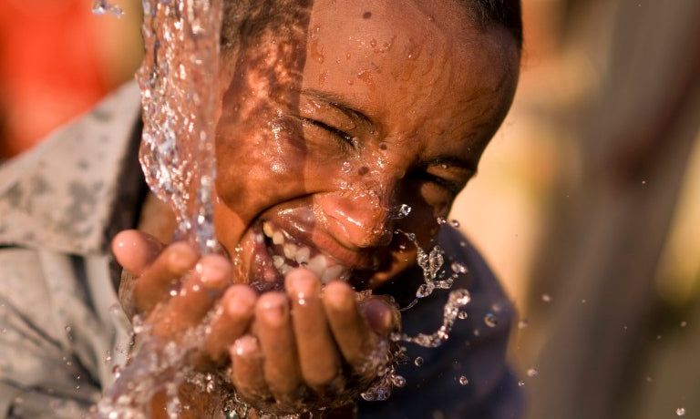un garcon boie de l'eau